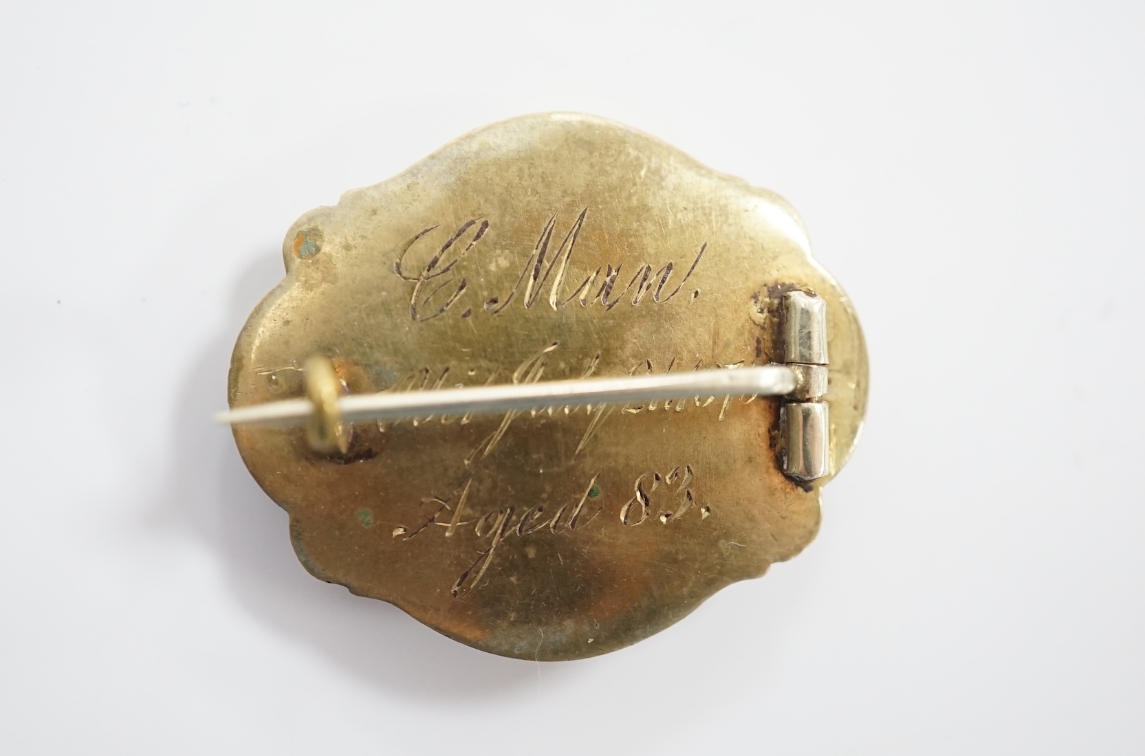Three assorted late 19th/early 20th century yellow metal mounted mourning brooches, including black enamel and split pearl inscribed 'JMMM. BJBW. JBMW. 23rd Oct Gallipoli 1915', 45mm and a garnet and split pearl. Conditi
